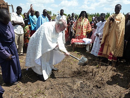 Fr. Joseph takes a turn breaking ground. Fr. George is to the right<br> in gold vestments. Metropolitan Jonah is in the background.